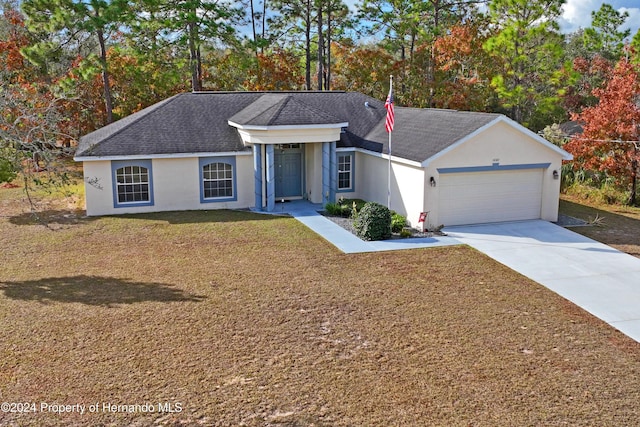 ranch-style home featuring a front yard and a garage