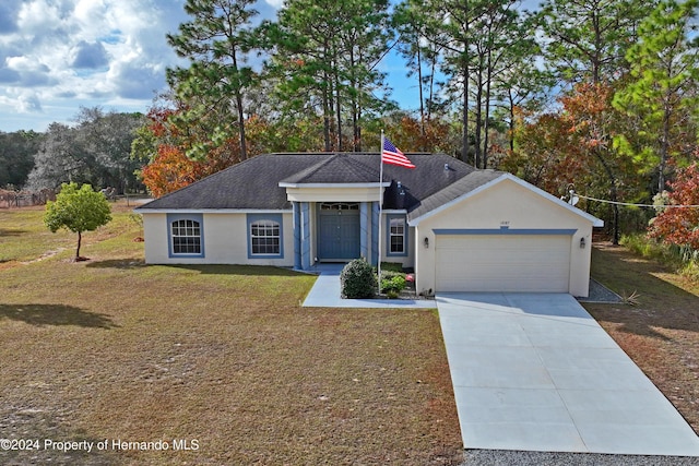 single story home with a garage and a front lawn