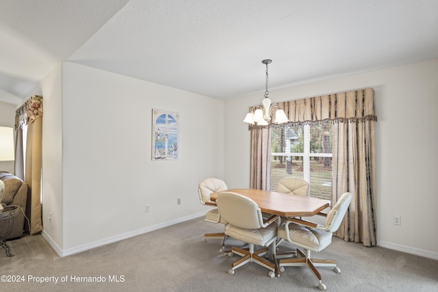 carpeted dining space with a notable chandelier