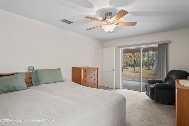 carpeted bedroom with ceiling fan and access to exterior