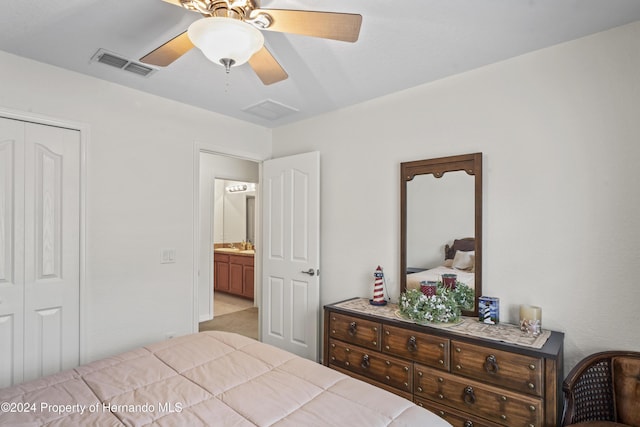 bedroom with ceiling fan, a closet, and light colored carpet