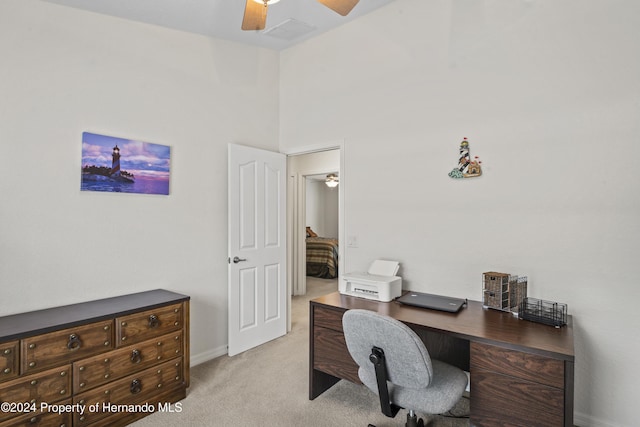 office area featuring light carpet and ceiling fan