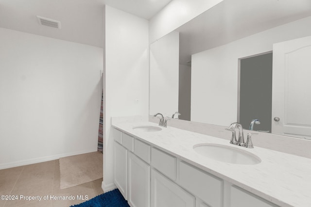 bathroom featuring tile patterned flooring and vanity