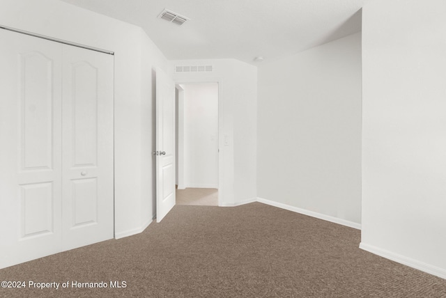 unfurnished bedroom featuring a closet and carpet