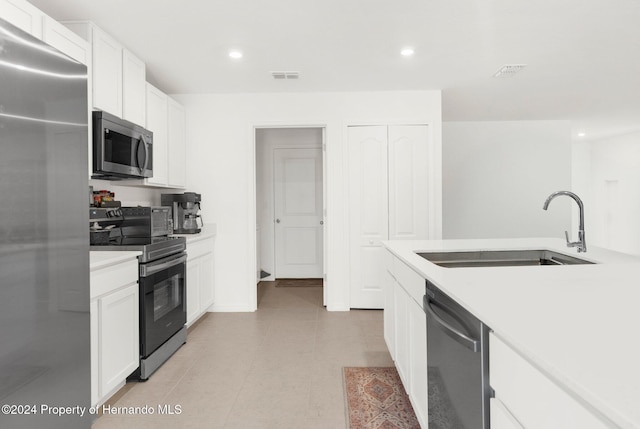 kitchen with white cabinets, stainless steel appliances, and sink