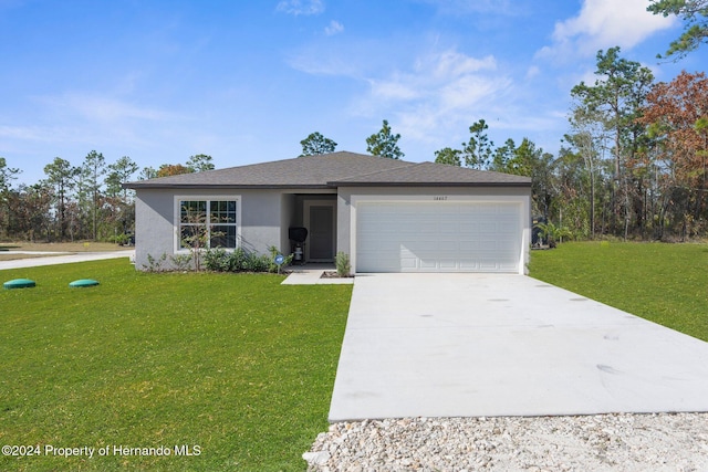 ranch-style house featuring a garage and a front lawn