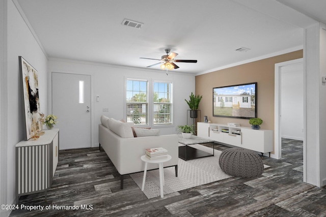 living room with ceiling fan, dark hardwood / wood-style flooring, and crown molding