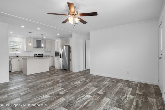 unfurnished living room with dark wood-type flooring, ornamental molding, and sink