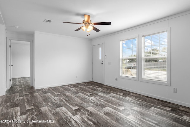 spare room with ceiling fan, crown molding, and dark hardwood / wood-style floors