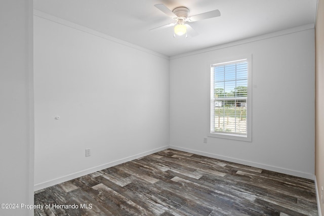 spare room with ceiling fan, dark wood-type flooring, and ornamental molding