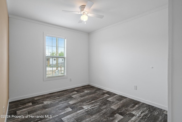 empty room featuring dark wood-type flooring, ceiling fan, and crown molding