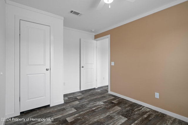 unfurnished bedroom with ceiling fan, dark hardwood / wood-style flooring, and crown molding