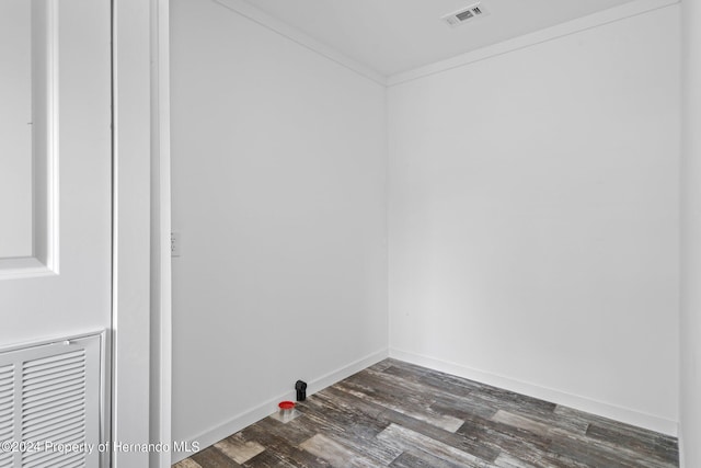 laundry room featuring dark hardwood / wood-style floors and ornamental molding