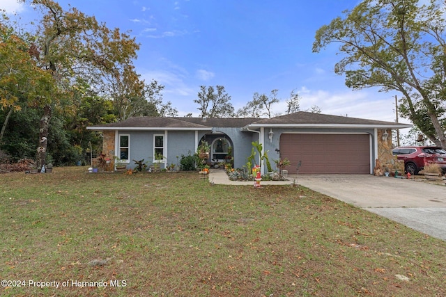 single story home with a garage and a front lawn