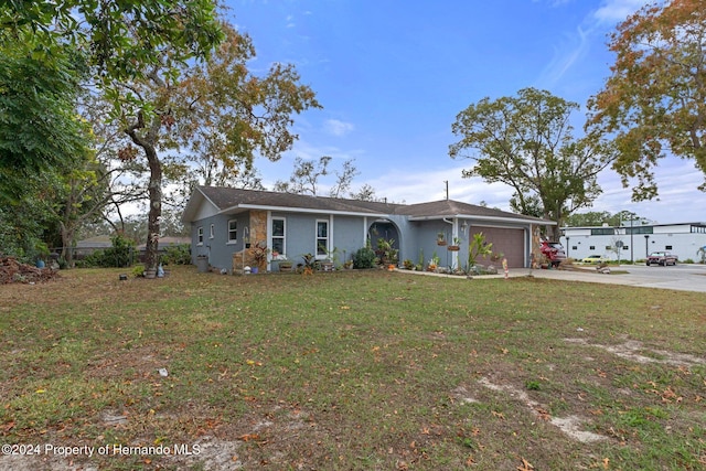 view of front of property featuring a garage and a front lawn