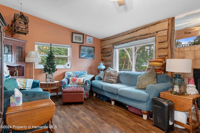 living room featuring dark hardwood / wood-style floors, ceiling fan, and lofted ceiling