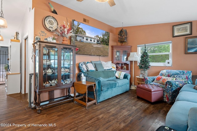 living room featuring ceiling fan, dark hardwood / wood-style flooring, and vaulted ceiling