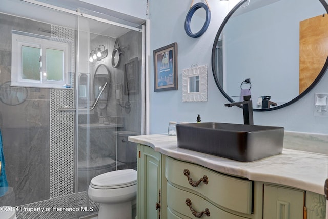 bathroom with vanity, toilet, and walk in shower