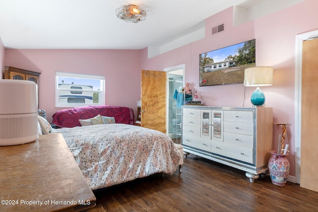 bedroom featuring dark hardwood / wood-style floors and lofted ceiling