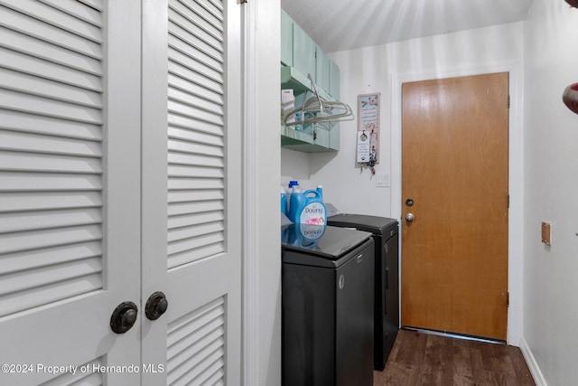 laundry area featuring separate washer and dryer and dark hardwood / wood-style floors