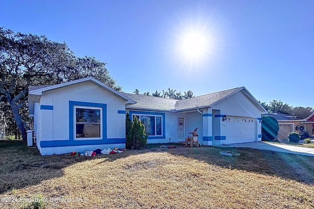 ranch-style house featuring a garage and a front yard