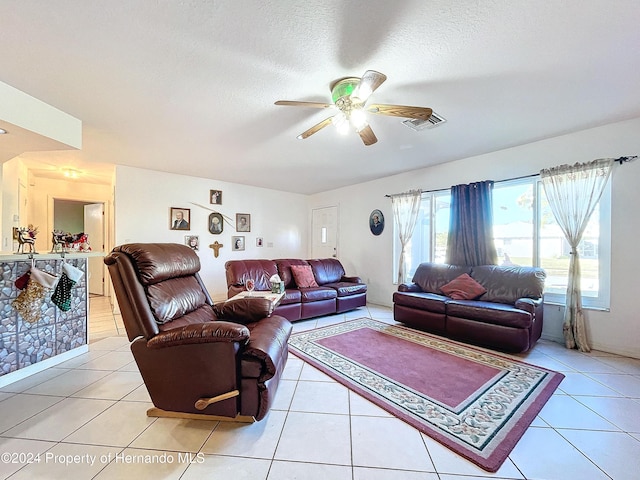 tiled living room featuring ceiling fan and a textured ceiling