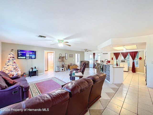 tiled living room with ceiling fan