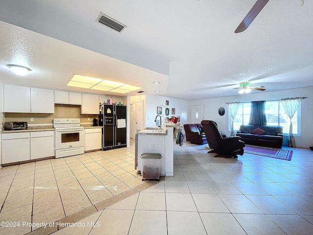 kitchen featuring white cabinetry, sink, black refrigerator with ice dispenser, white electric stove, and light tile patterned floors