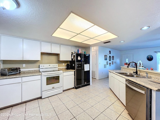 kitchen featuring dishwasher, black fridge, white cabinets, and white electric stove