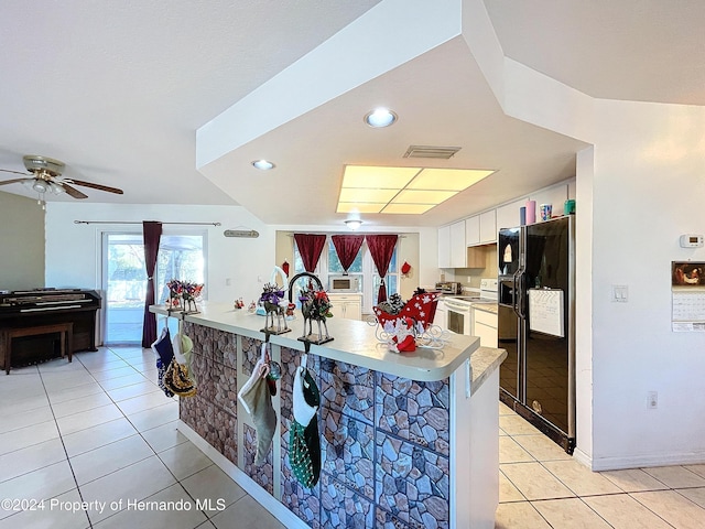 kitchen featuring black refrigerator with ice dispenser, electric stove, kitchen peninsula, light tile patterned flooring, and white cabinetry