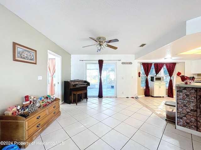 interior space featuring ceiling fan and a textured ceiling