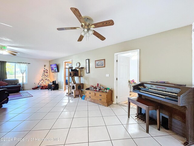 misc room with ceiling fan and light tile patterned flooring