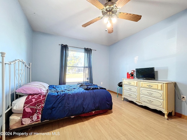 bedroom with ceiling fan and light hardwood / wood-style flooring