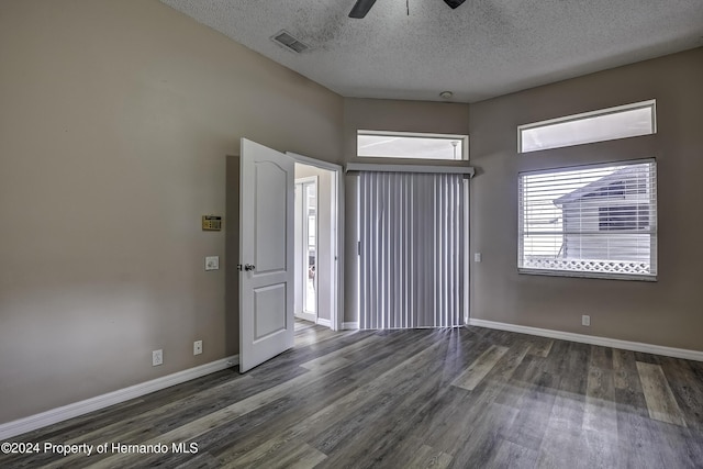 unfurnished room featuring baseboards, visible vents, a ceiling fan, wood finished floors, and a textured ceiling