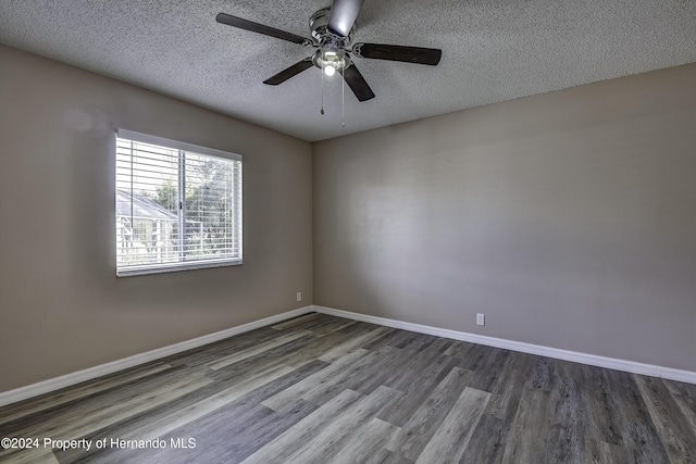 unfurnished room featuring ceiling fan, a textured ceiling, baseboards, and wood finished floors