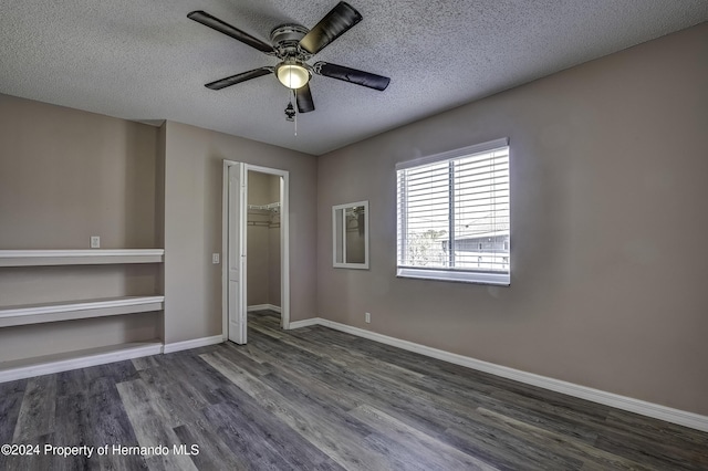 unfurnished bedroom featuring baseboards, ceiling fan, wood finished floors, a textured ceiling, and a closet