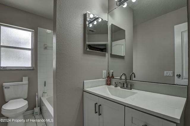 full bathroom with tub / shower combination, a textured ceiling, vanity, tile patterned flooring, and toilet