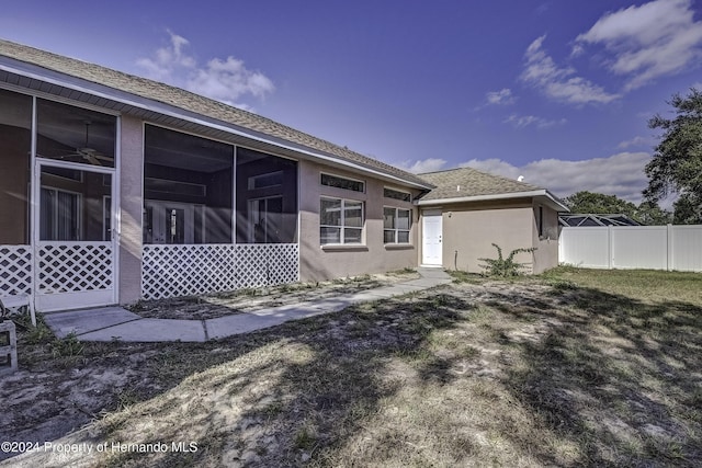 back of house featuring a sunroom