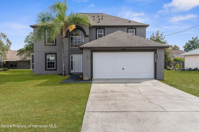 view of property with a garage and a front yard