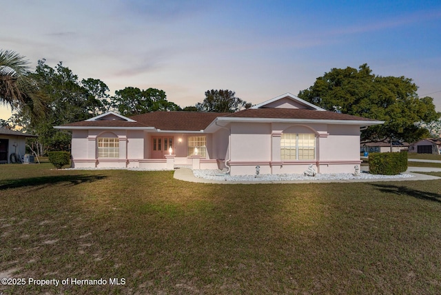 single story home with a lawn