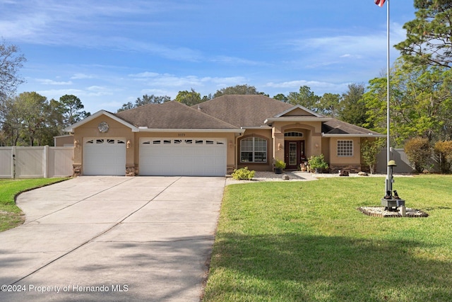 single story home with a front yard and a garage