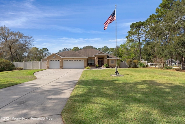 view of front of house with a garage and a front lawn