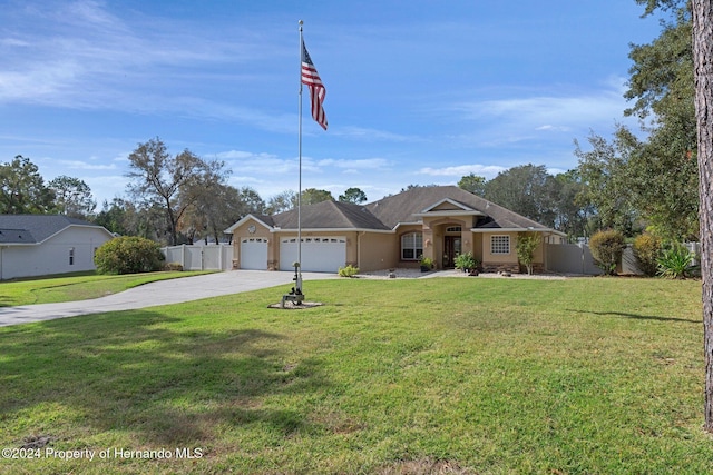 ranch-style home with a front yard and a garage