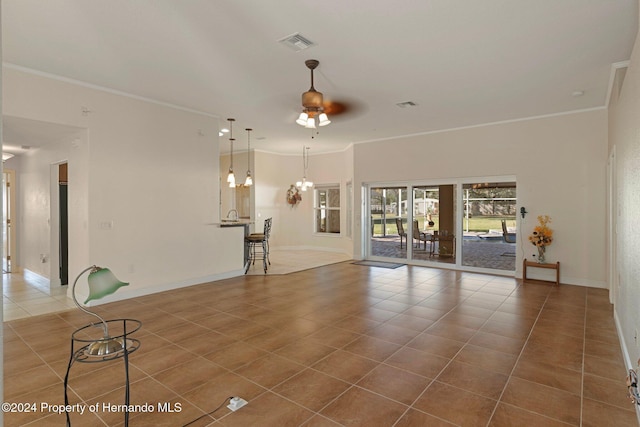 unfurnished living room featuring tile patterned floors, ceiling fan, and ornamental molding