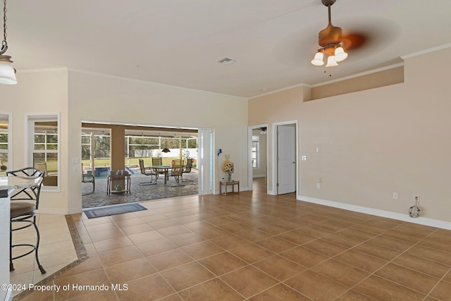 interior space featuring ceiling fan and crown molding