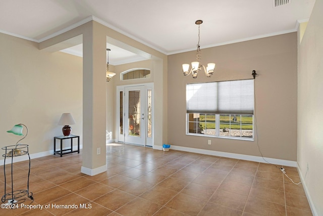 tiled foyer with ornamental molding and a notable chandelier