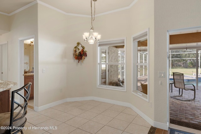 dining area featuring light tile patterned floors, sink, ornamental molding, and a notable chandelier