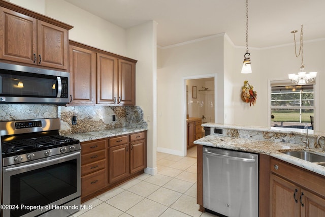 kitchen featuring appliances with stainless steel finishes, light stone counters, sink, light tile patterned floors, and an inviting chandelier