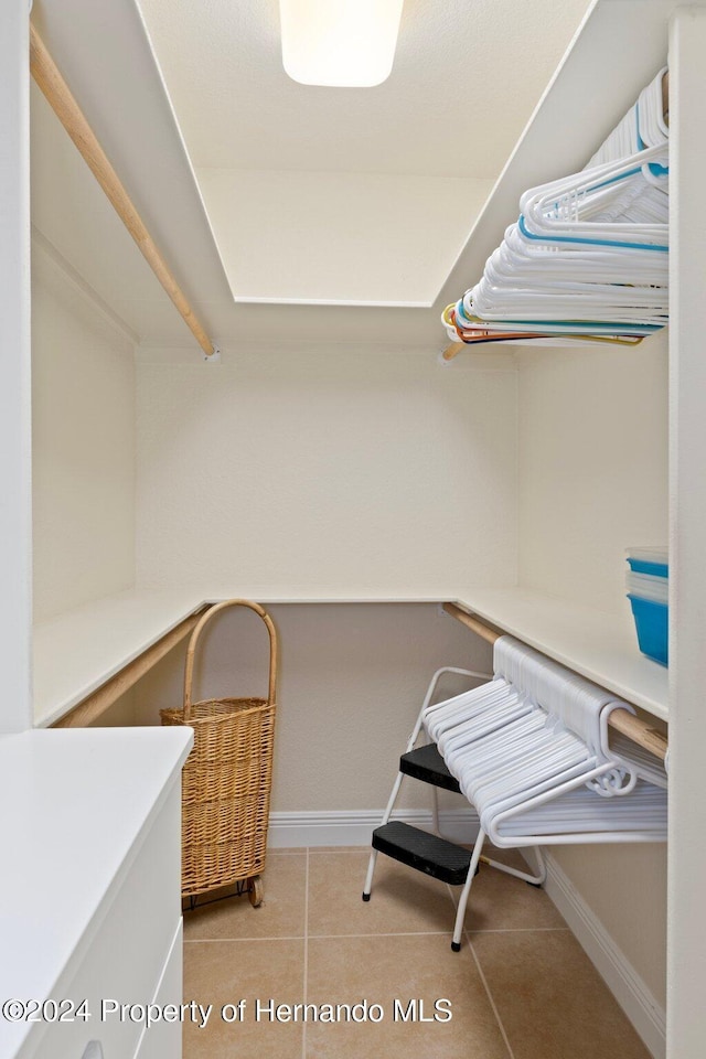 spacious closet with light tile patterned floors