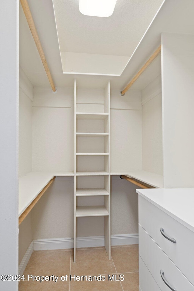 spacious closet with light tile patterned flooring